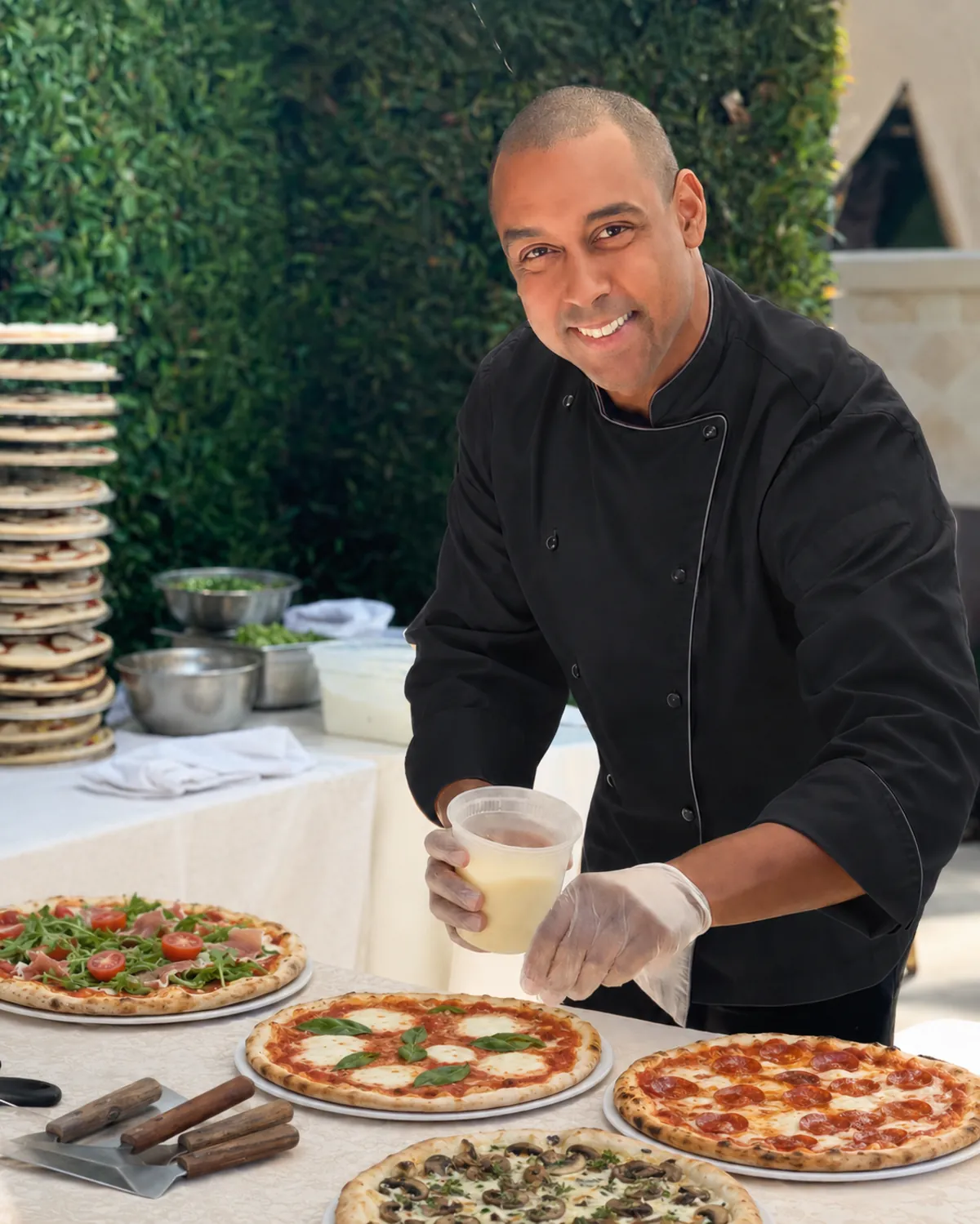 Chef Marcus Roberto preparing fresh pizzas on site at a Los Angeles catering event